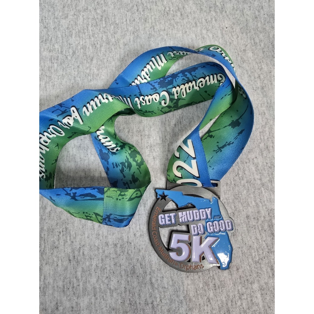 finisher medal for the 2022 "Get Muddy and Do Good" 5K